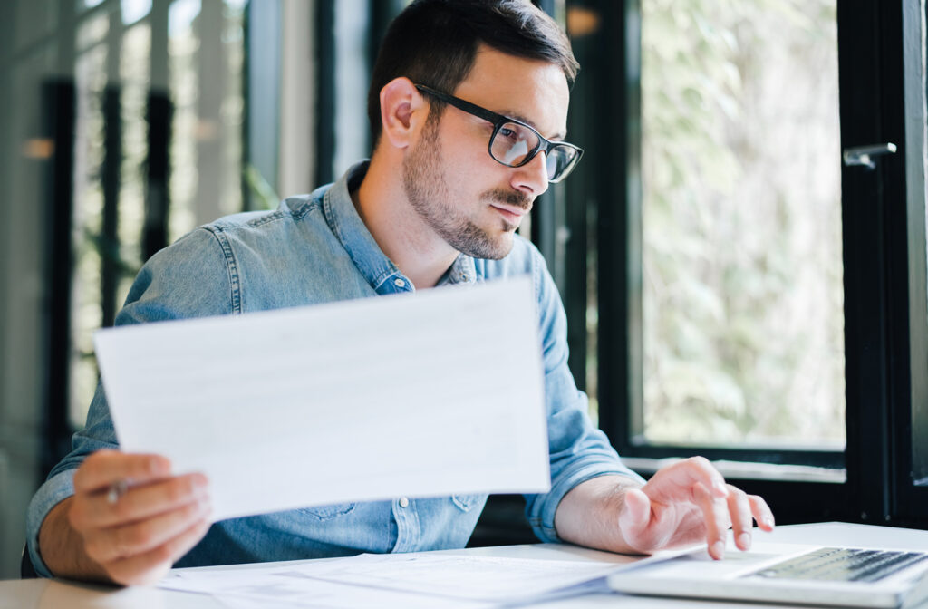 An accountant at his desk on a laptop